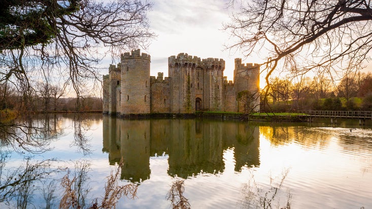 The castle and moat with sunshine behind the castle in winter, Bodiam Castle, East Sussex